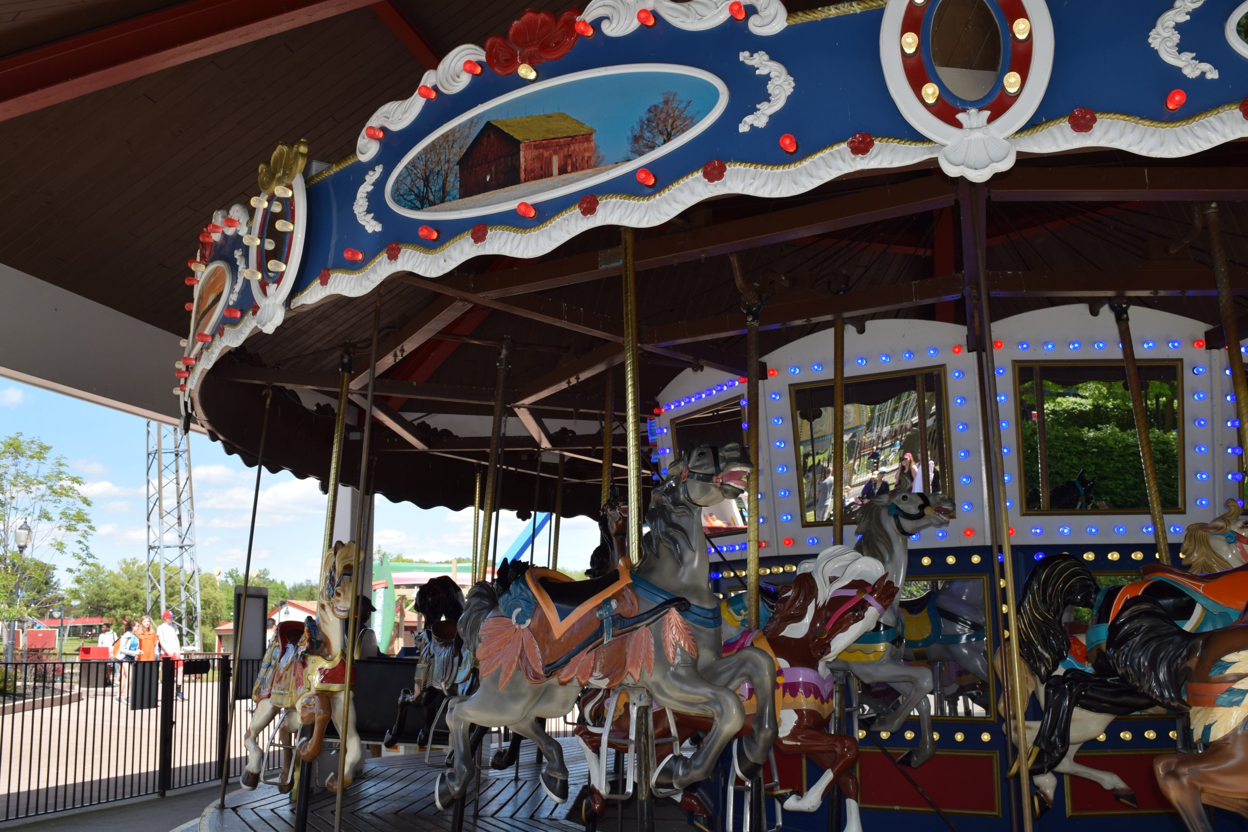 People smiling riding the carousel.