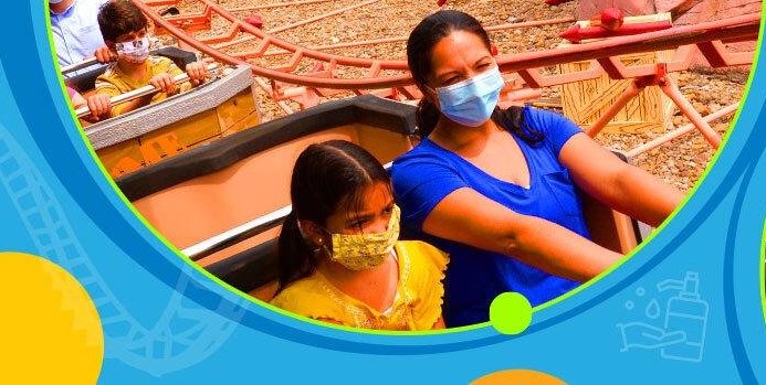 Guest riding a ride with masks on