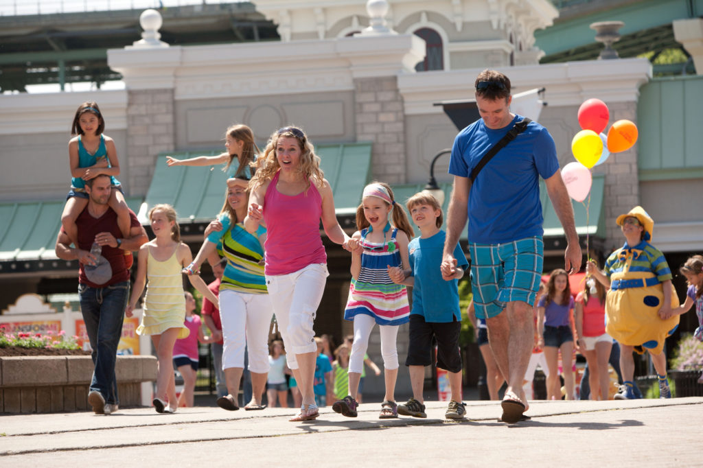 A family walking through the Six Flags theme park