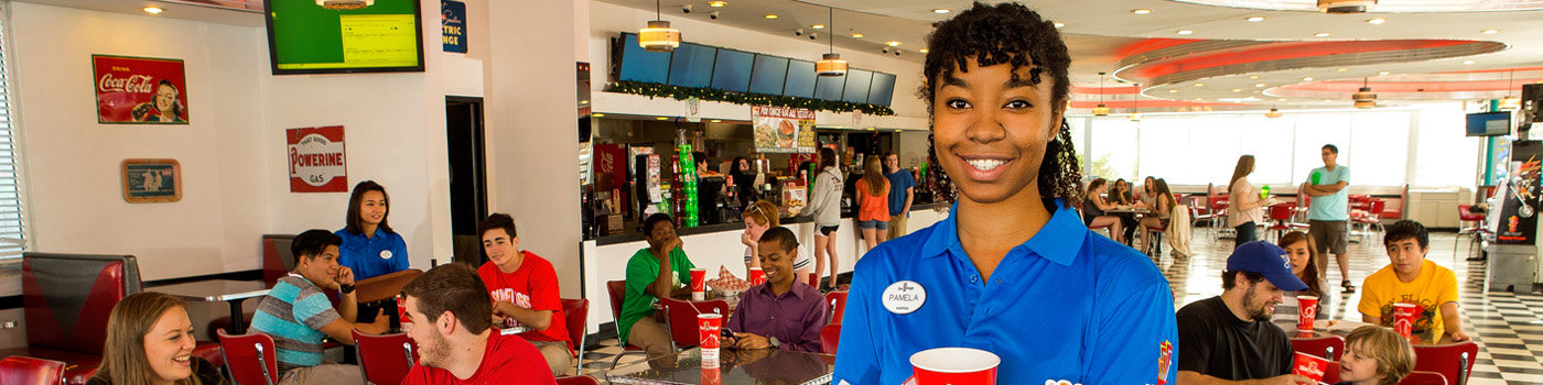 Six Flags is hiring! Six Flags wait staff helping guests at park restaurant.