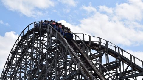 Guests riding the wooden predator coaster at Six Flags